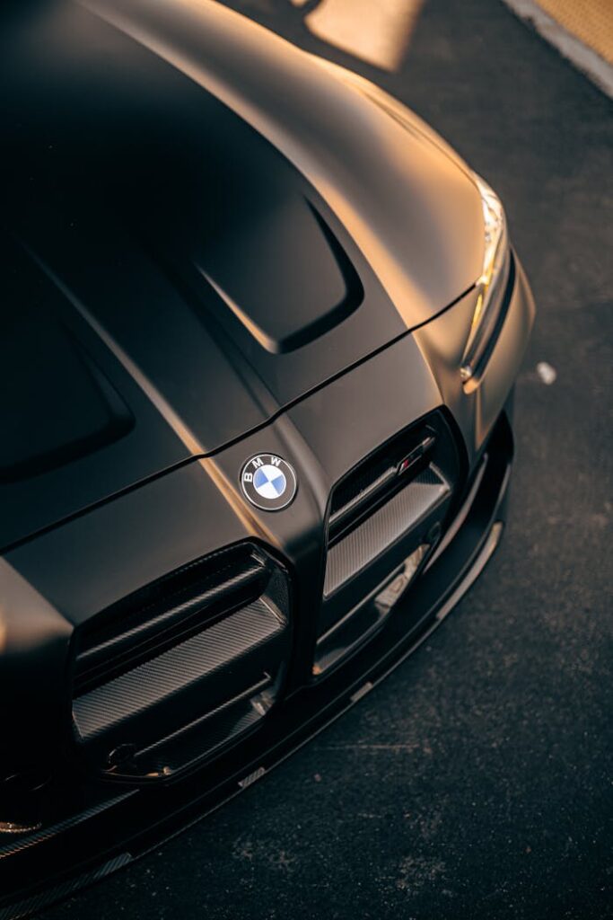 An artistic close-up of a luxury car grille at twilight in San Jose, CA.